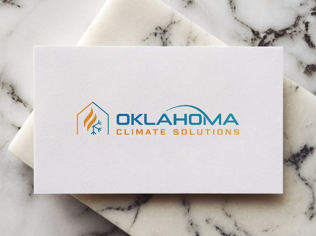 A white Oklahoma Climate Solutions business card resting on marble