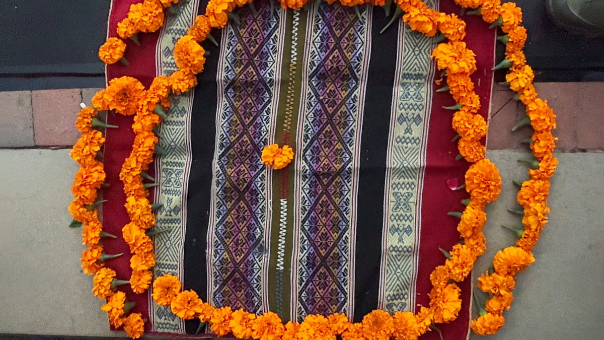 The marigold altar the film’s date card sits on