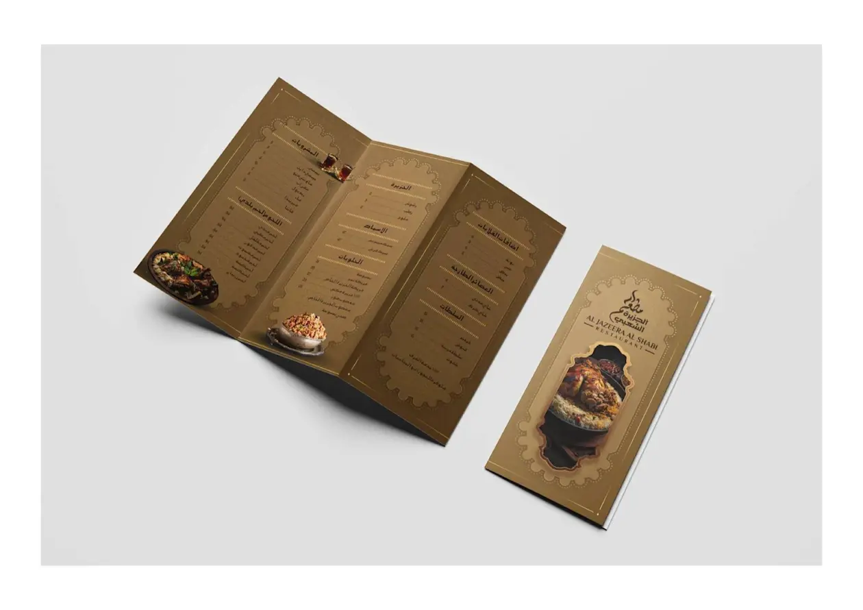 Trifold restaurant brochure with gold design showcasing menu layout and dish imagery.
